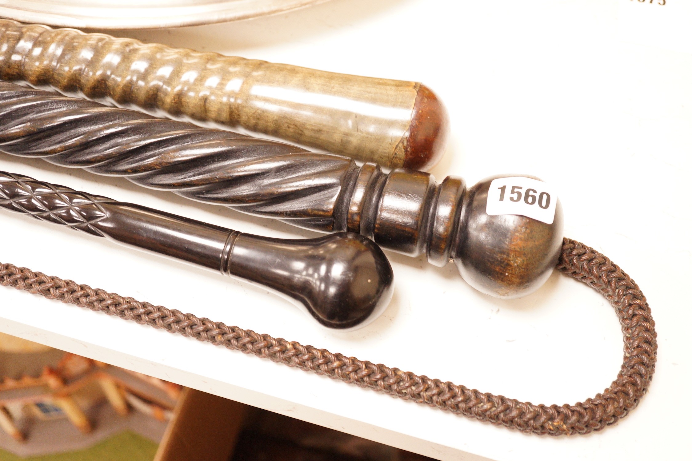 Four assorted canes to include a tapering horn example, a woven example, etc